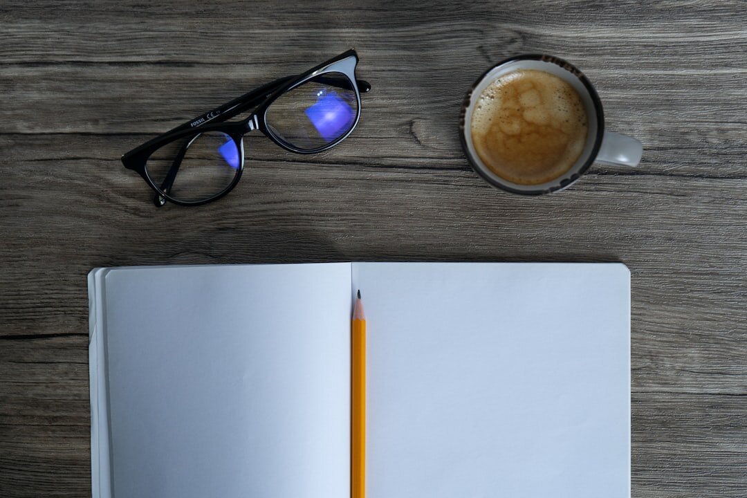 Overhead view of a desk with notebook and coffee